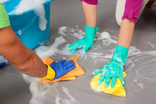 Staff member wearing PPE during carpet cleaning in SW13
