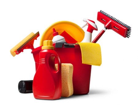 Cleaner tidying a bright family living room in SW13